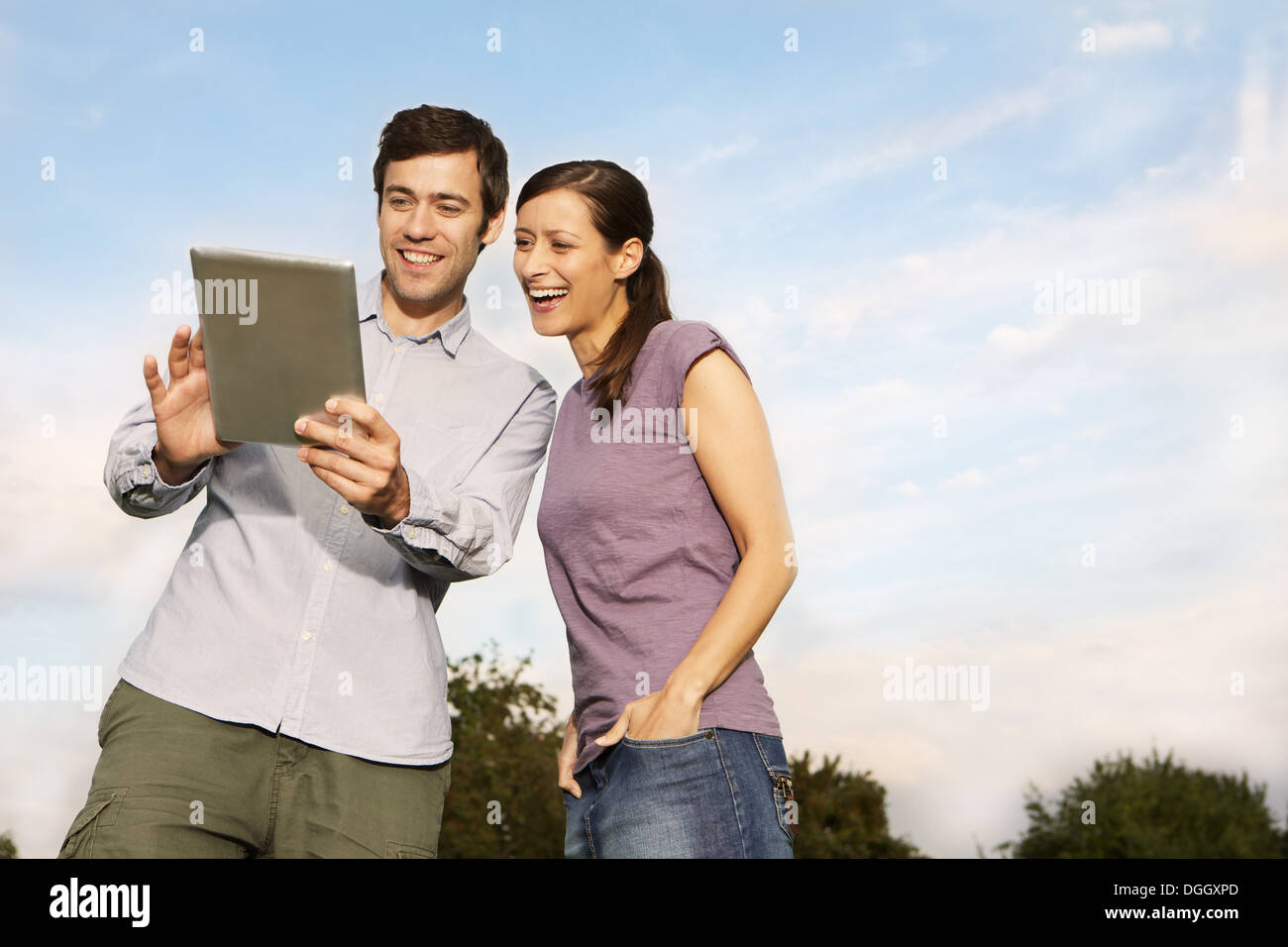 Mid adult couple using digital tablet Stock Photo