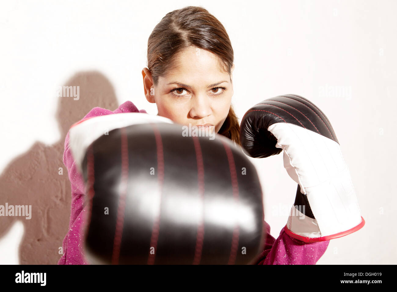 Young woman wearing boxing gloves Stock Photo