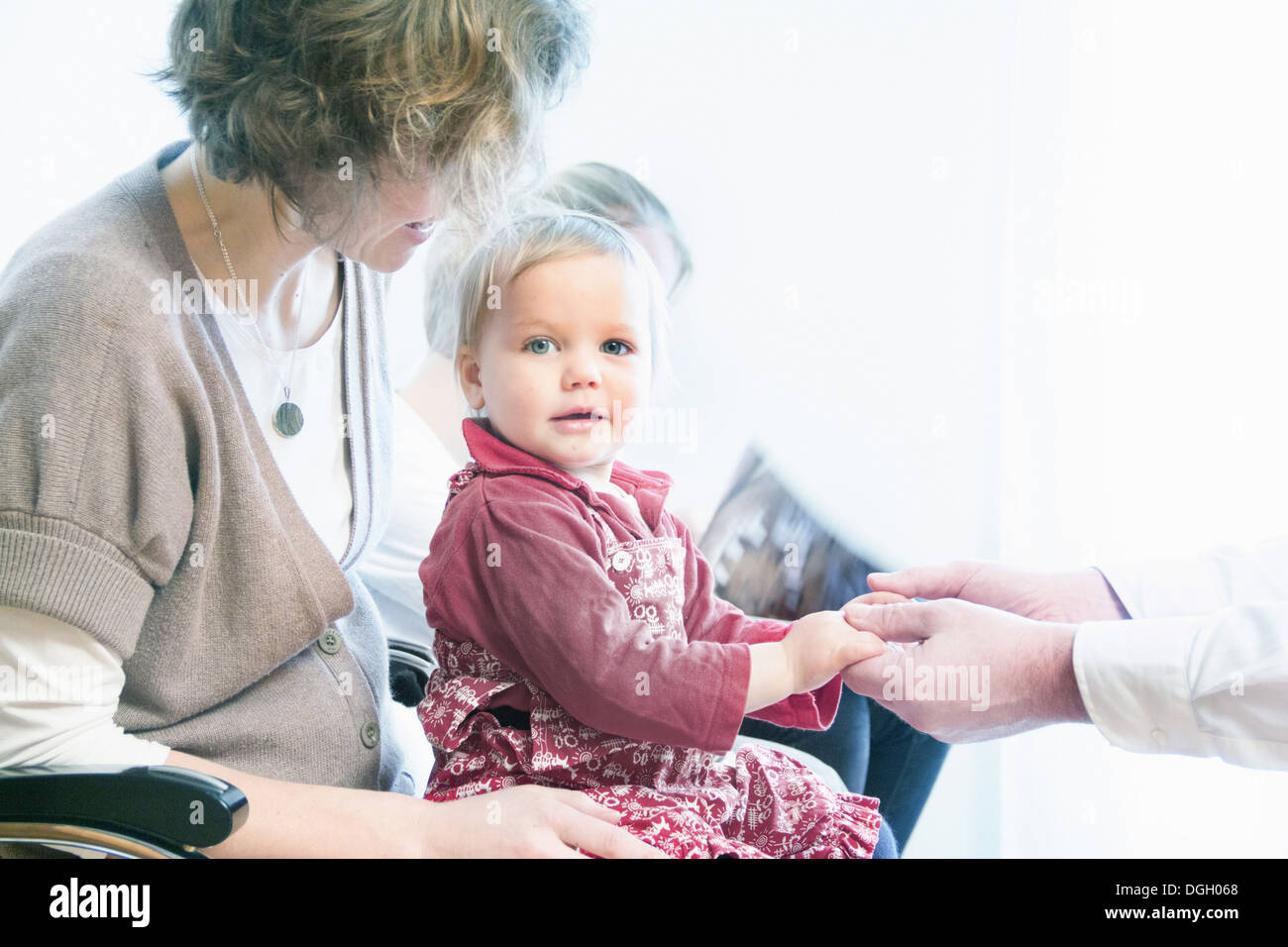 examined child Child on mother's lap being examined by doctor Stock Photo - Alamy