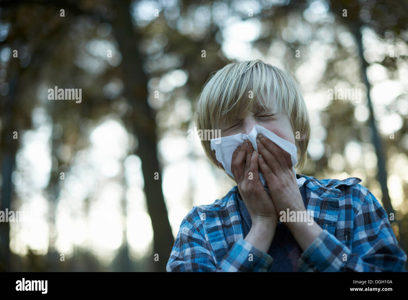 Boys blowing his nose Stock Photo Alamy