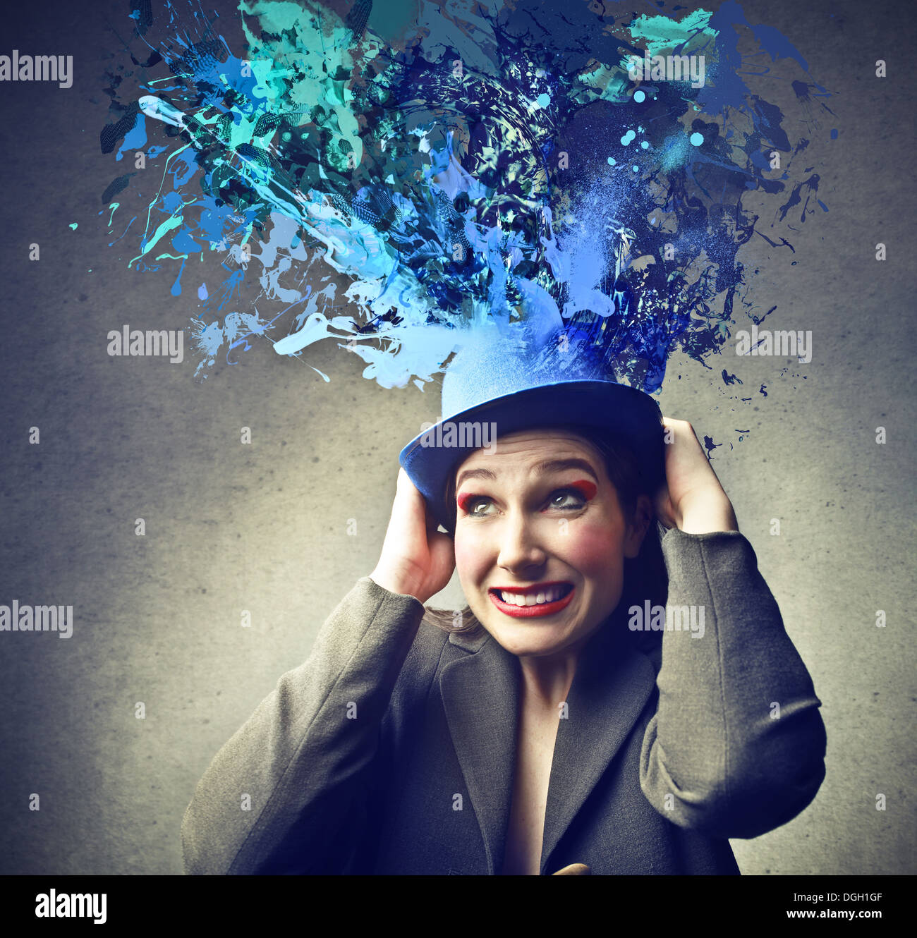 Elegant woman with a blue hat from which coming out blue paint Stock Photo