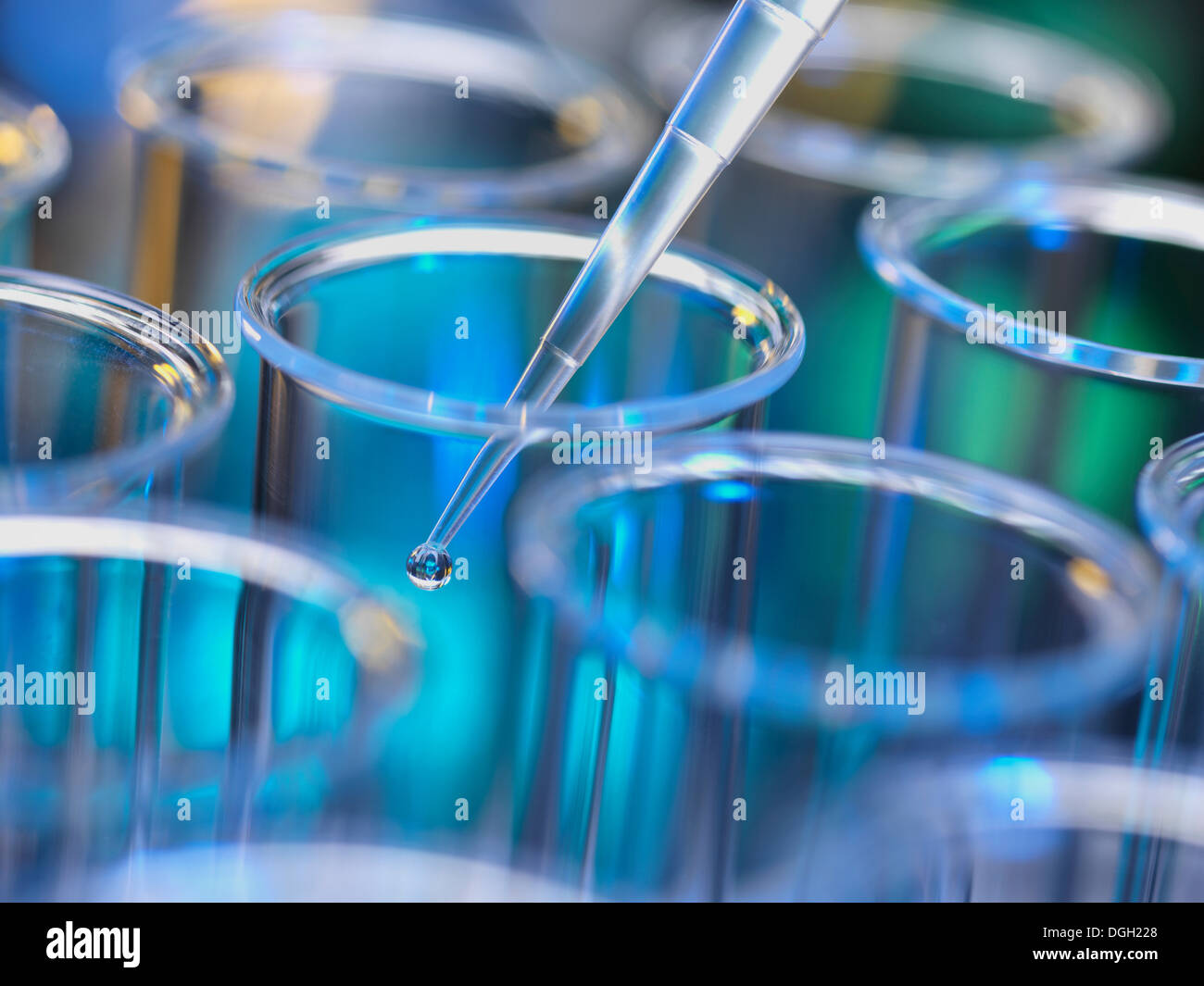 Analytical chemistry - sample being pipetted into test tube for analysis in laboratory Stock Photo