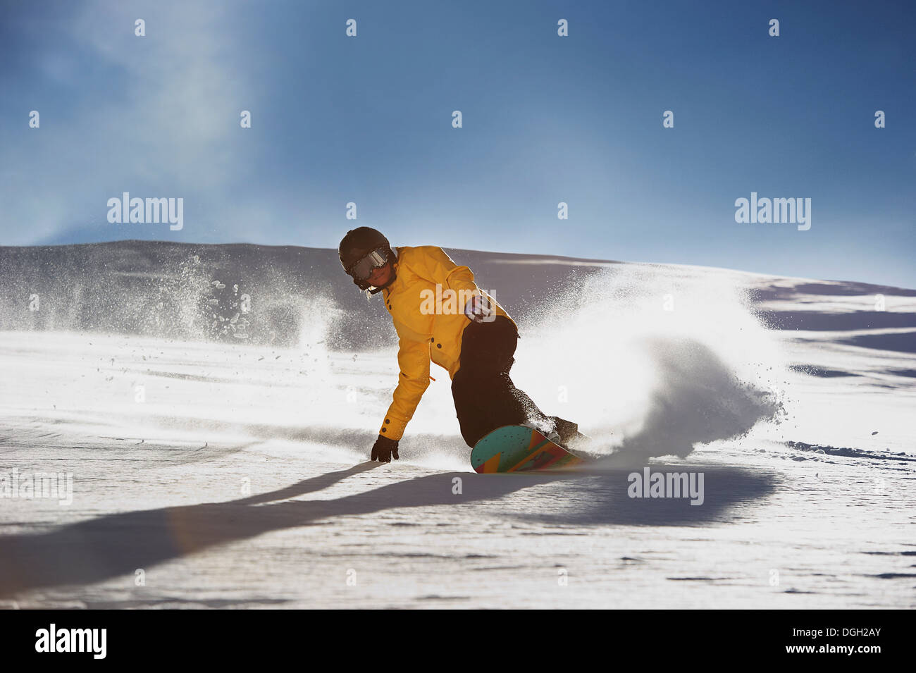 Young woman snowboarding Stock Photo