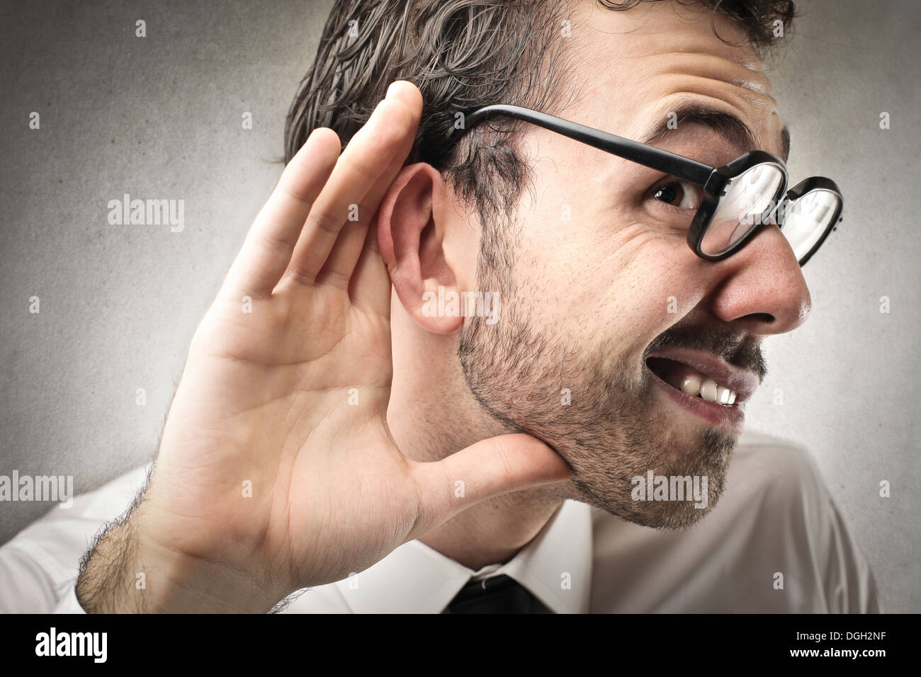 Office worker with glasses can't hear someone Stock Photo