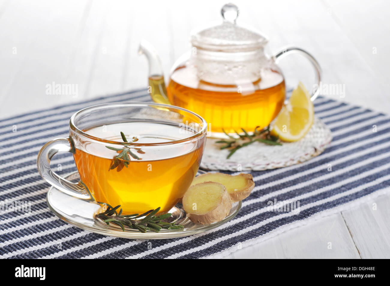 Ginger tea with lemon and rosematy in glass cup closeup. Stock Photo