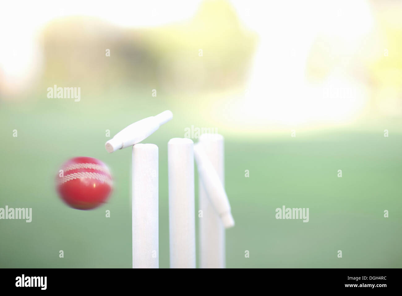 Cricket ball hitting cricket stumps, close up Stock Photo
