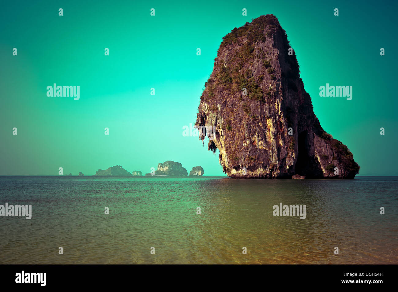 Tropical beach view in vintage style. Ocean landscape with rock formation island at Pranang cave beach, Railay, Krabi, Thailand Stock Photo