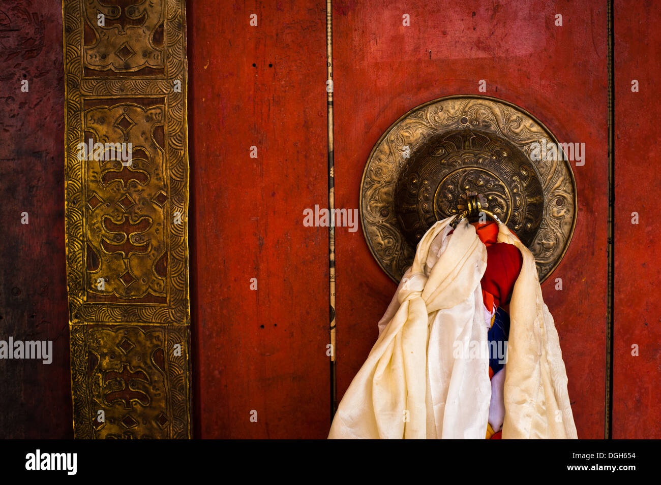 Old door at Buddhist monastery temple decorated with ancient doorknob and tassel. India, Ladakh, Diskit monastery Stock Photo