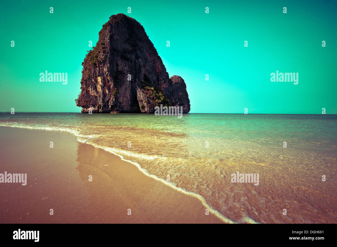 Tropical beach view in vintage style. Ocean landscape with rock formation island at Pranang cave beach, Railay, Krabi, Thailand Stock Photo