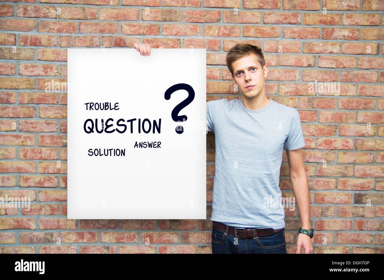 Young man holding whiteboard with question and solution words Stock Photo