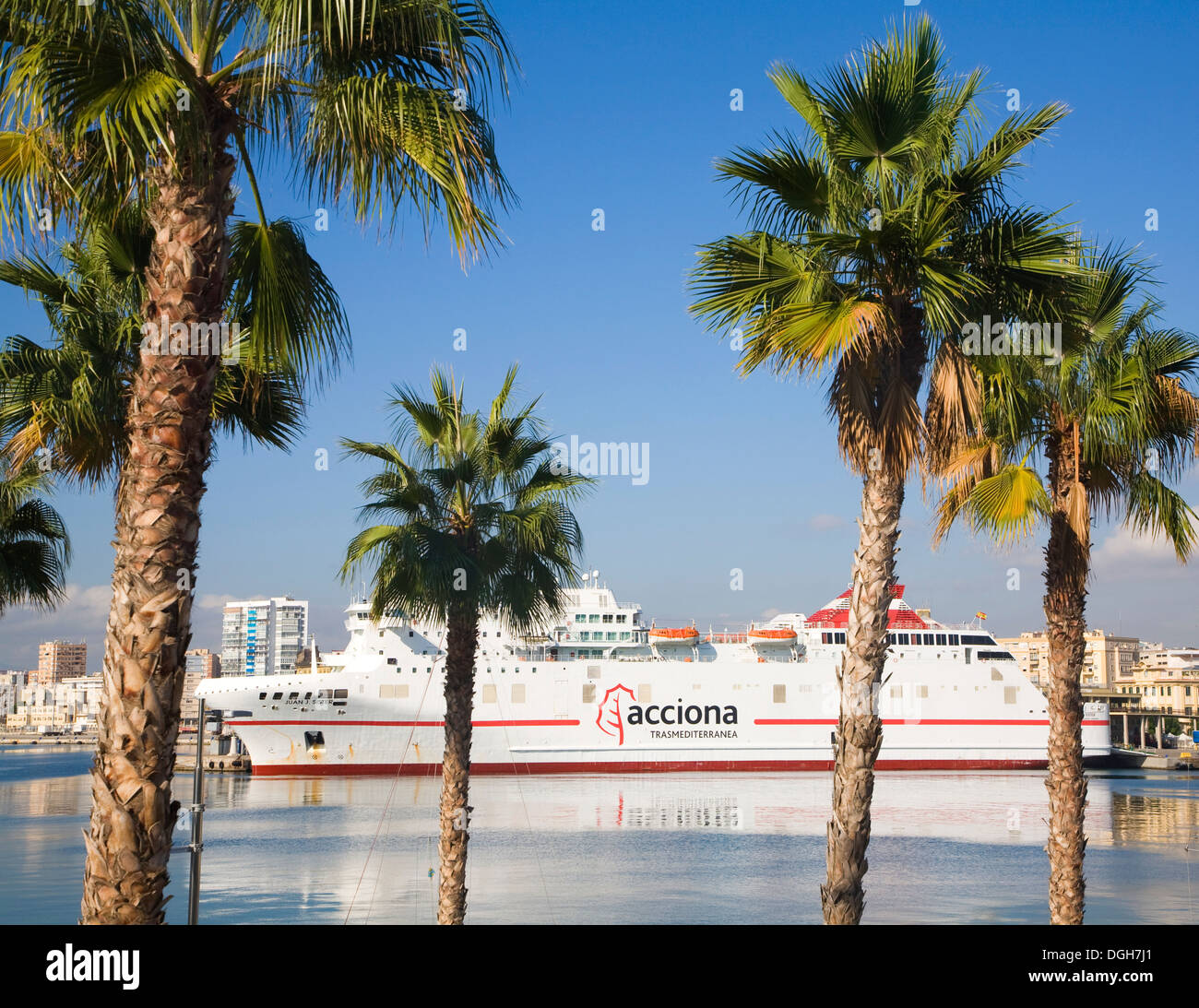 View  through palm trees to acciona ferry ship Malaga Spain Stock Photo