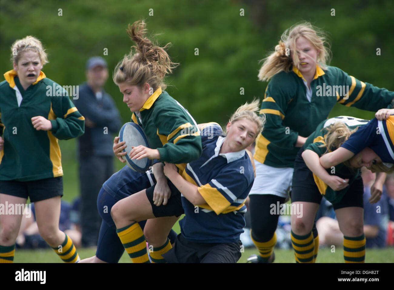 girl being tackled in rugby game Stock Photo