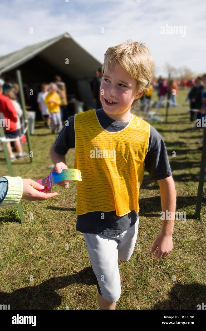 boy accepting ribbon for cross country race Stock Photo