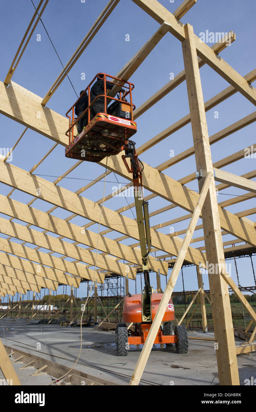 Construction work on farm building for loose housing, cherrypicker