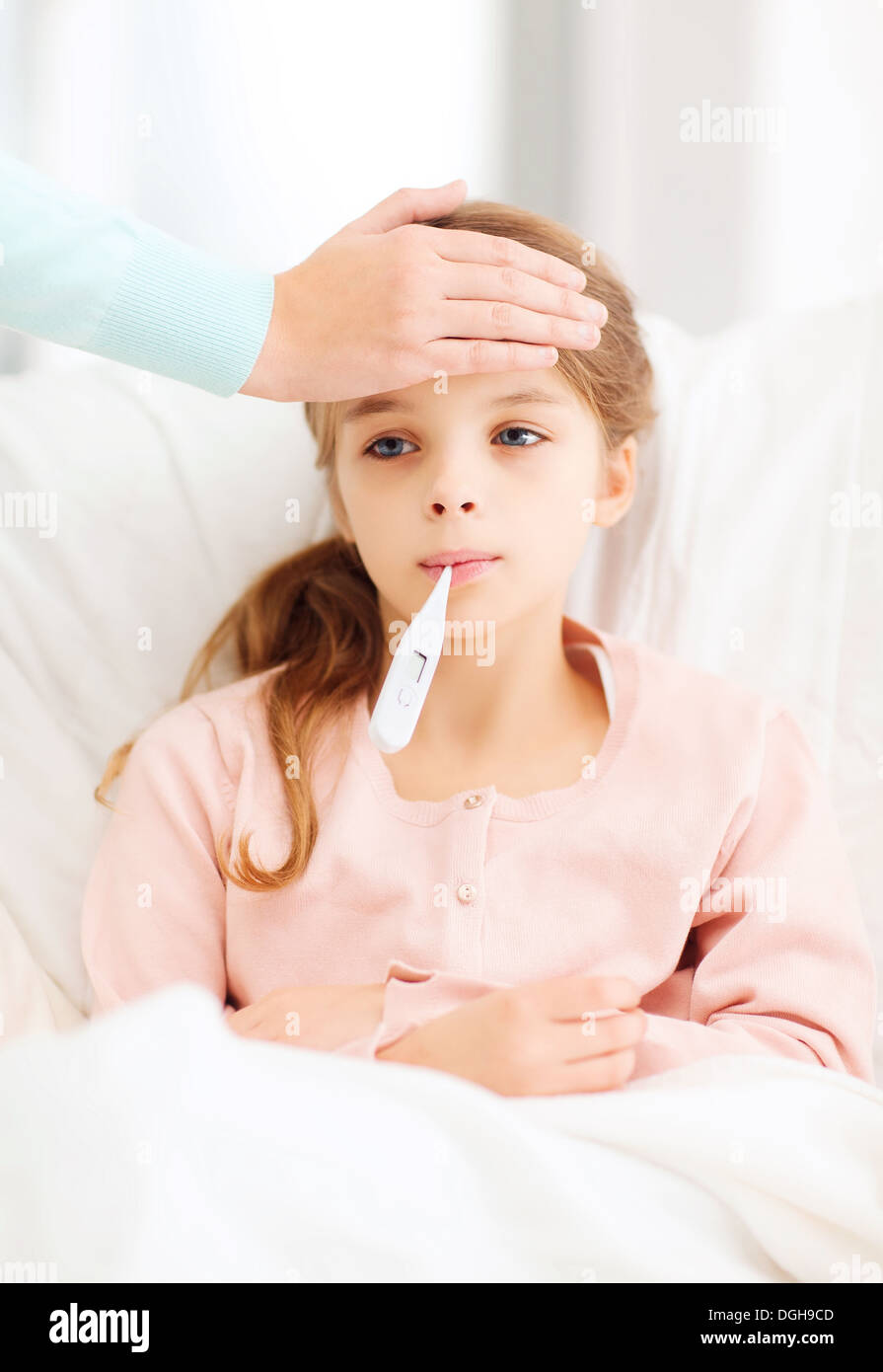 ill girl child with thermometer and caring mother Stock Photo Alamy