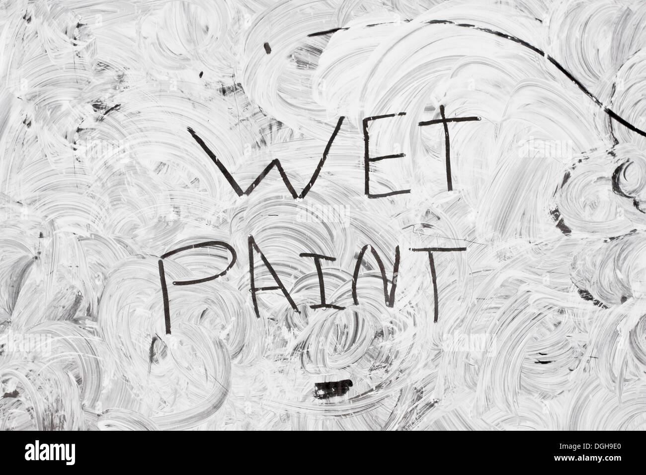 Wet white paint on a glass window Stock Photo