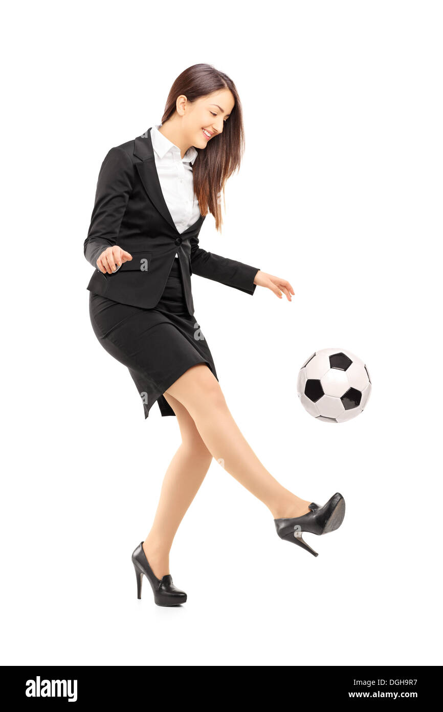 Full length portrait of a businesswoman in high heels kicking a ball  isolated on white background Stock Photo - Alamy