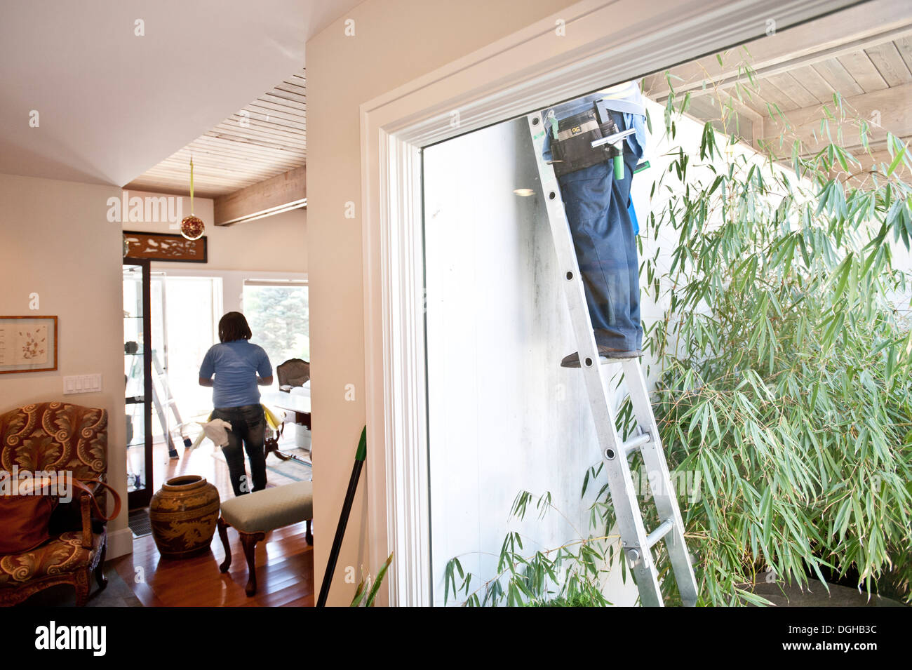 Employees of the New York's Little Elves cleaning company and a window