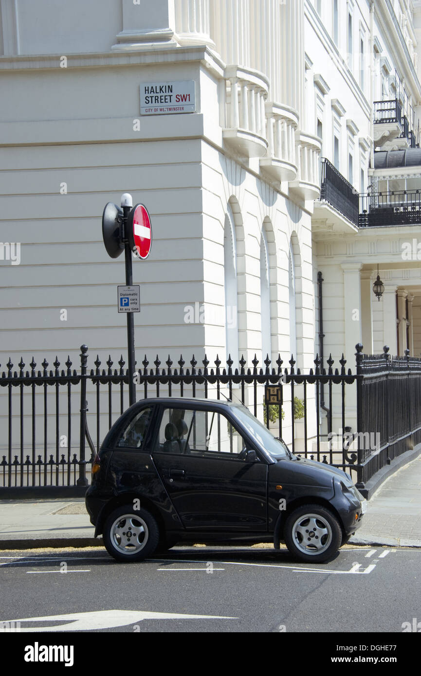 G-Wiz electric car parked on city street, Halkin Street, City of Westminster, London, England, april Stock Photo