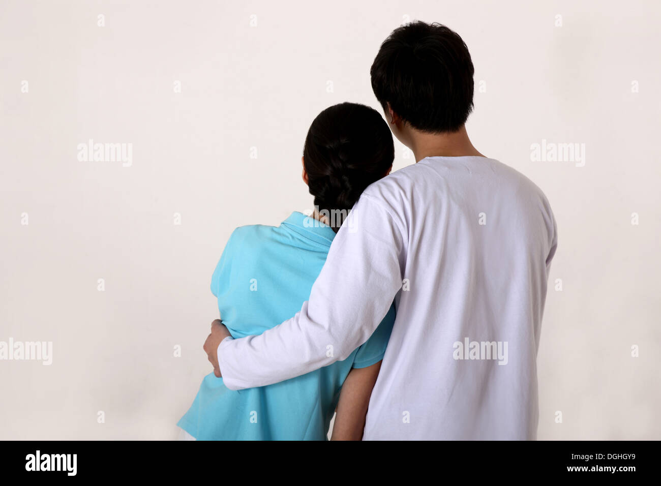 Back view of east Asian couple embracing Stock Photo