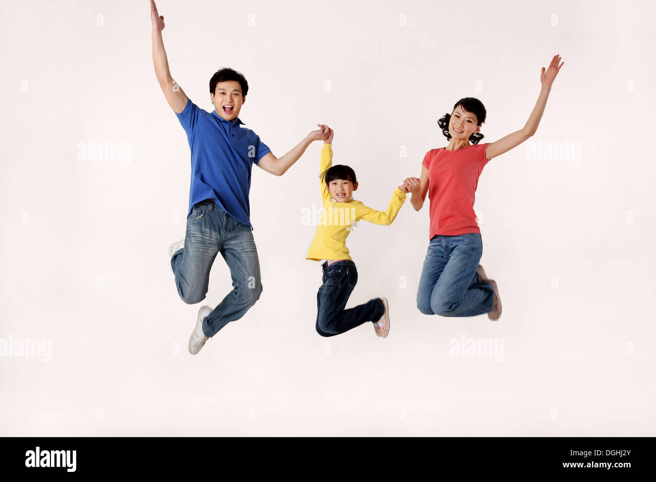 East asian family jumping hand in hand hires stock photography and