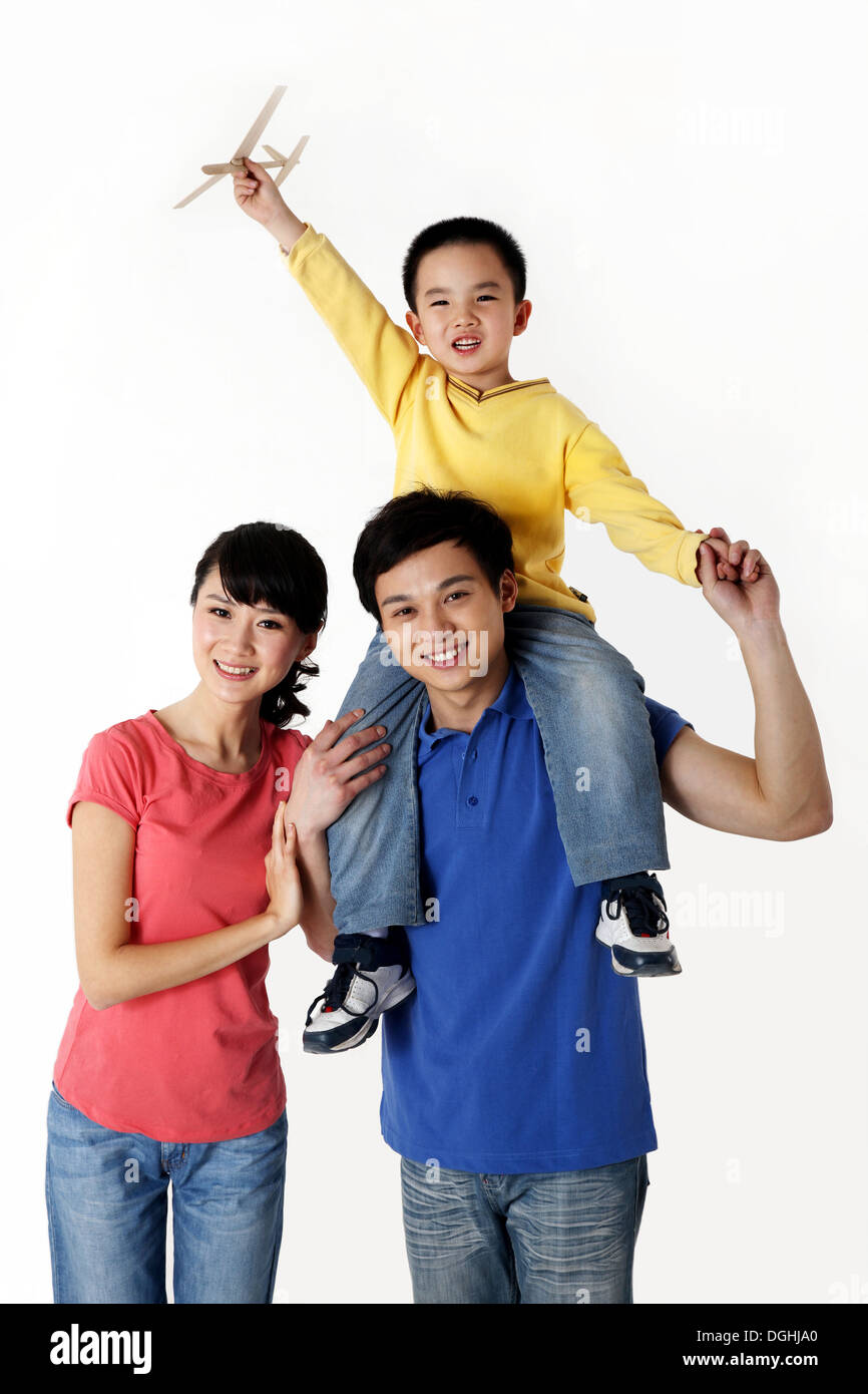 One Child Family Smiling, Looking at the Camera, Father Carrying Son on Shoulders Stock Photo