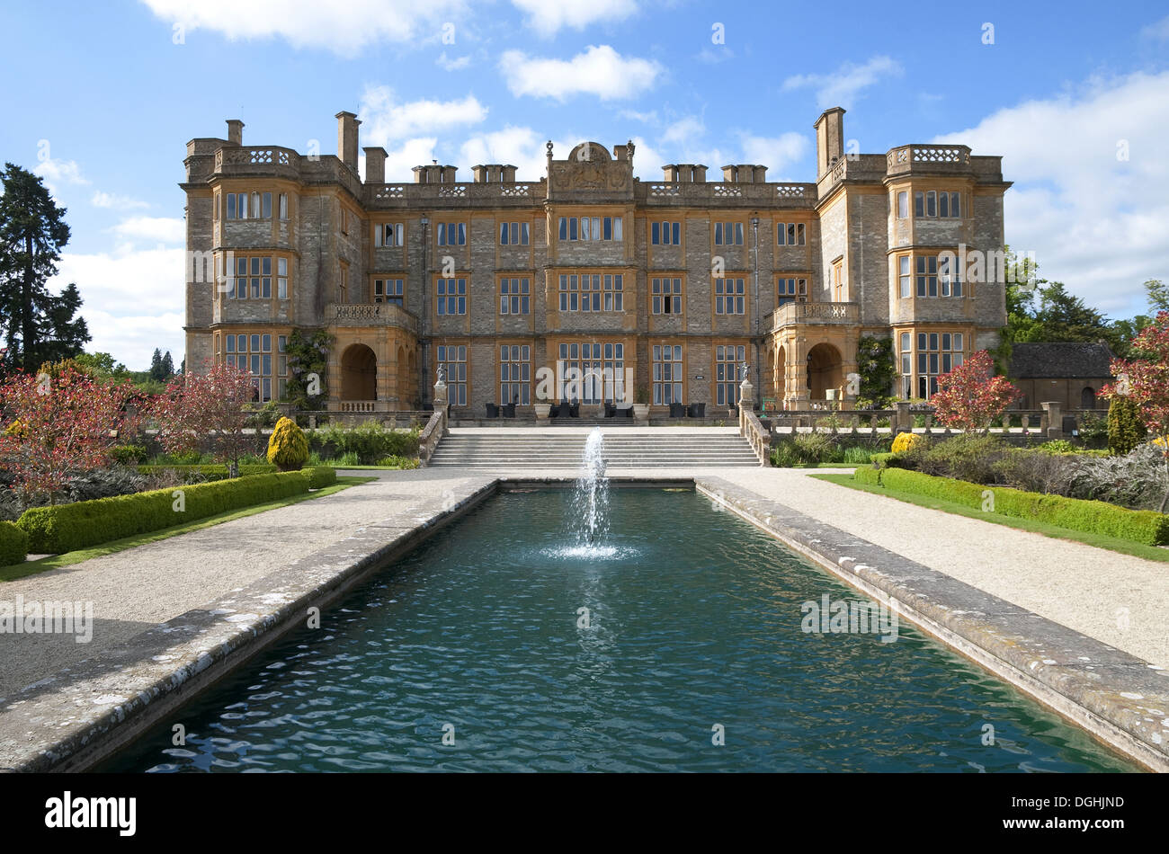 Jacobean-style mansion with garden and water feature, Eynsham Hall, Oxfordshire, England, June Stock Photo