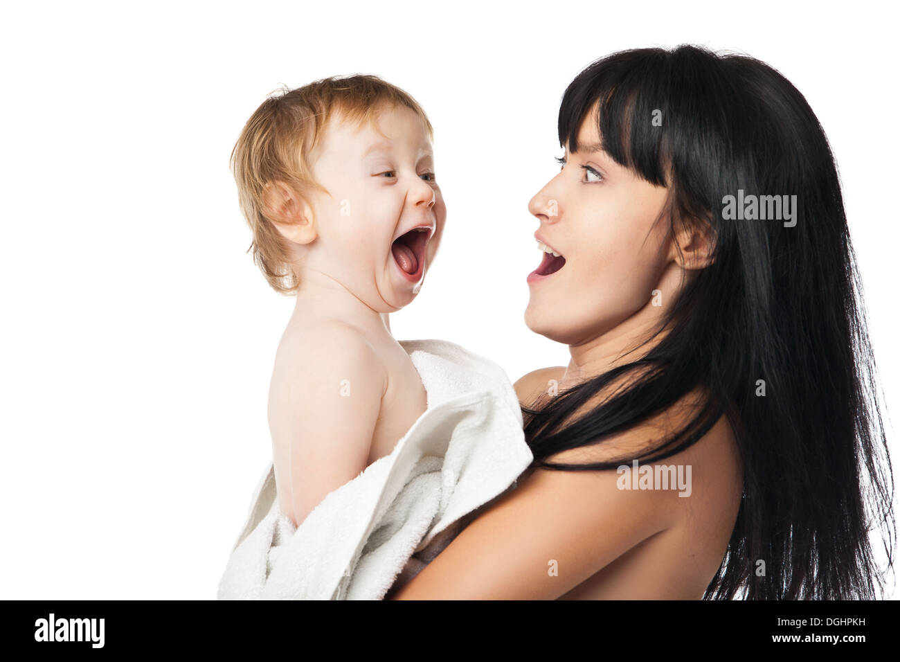 Mother with her baby after bathing in white towel Stock Photo
