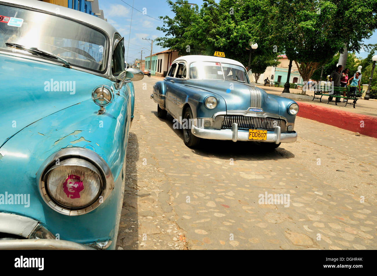 A Chevrolet and a Pontiac, two classic cars in the historic district of Trinidad, Cuba, Caribbean Stock Photo