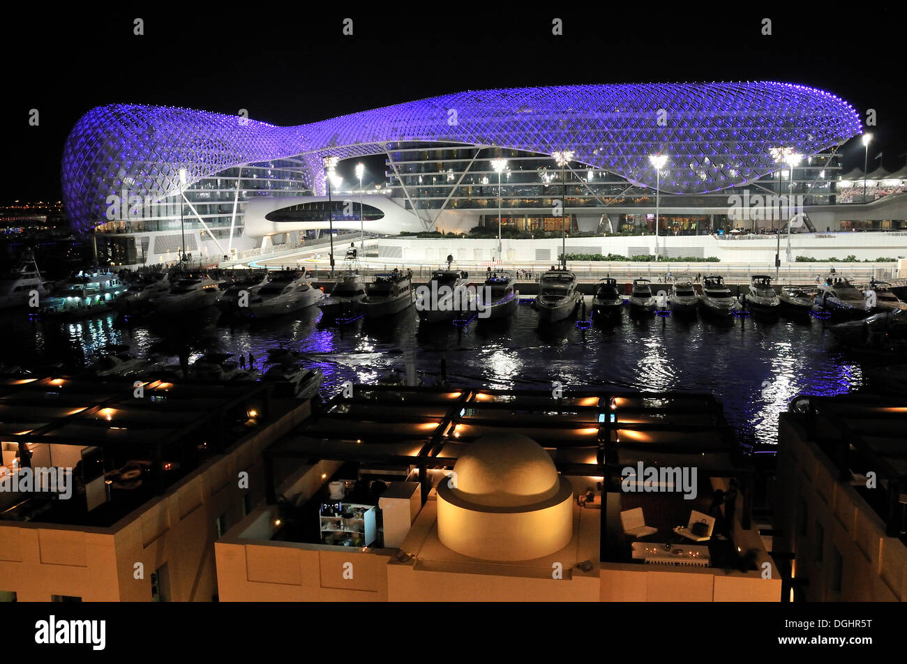Yas Hotel and marina at the Formula One racetrack Yas Marina Circuit on Yas Island at night, Abu Dhabi, United Arab Emirates Stock Photo