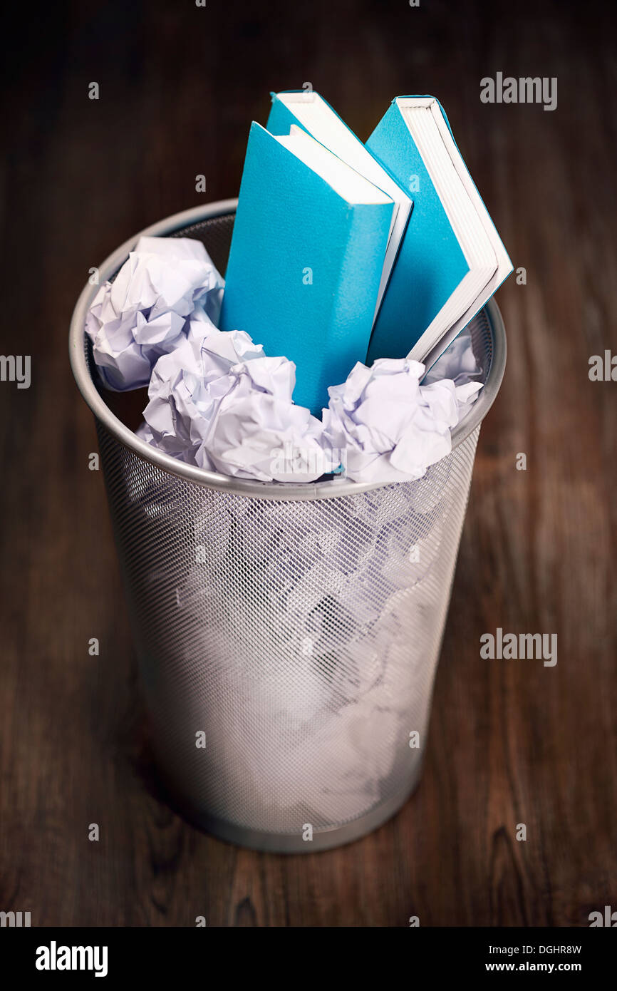 three books in a trash bin Stock Photo Alamy