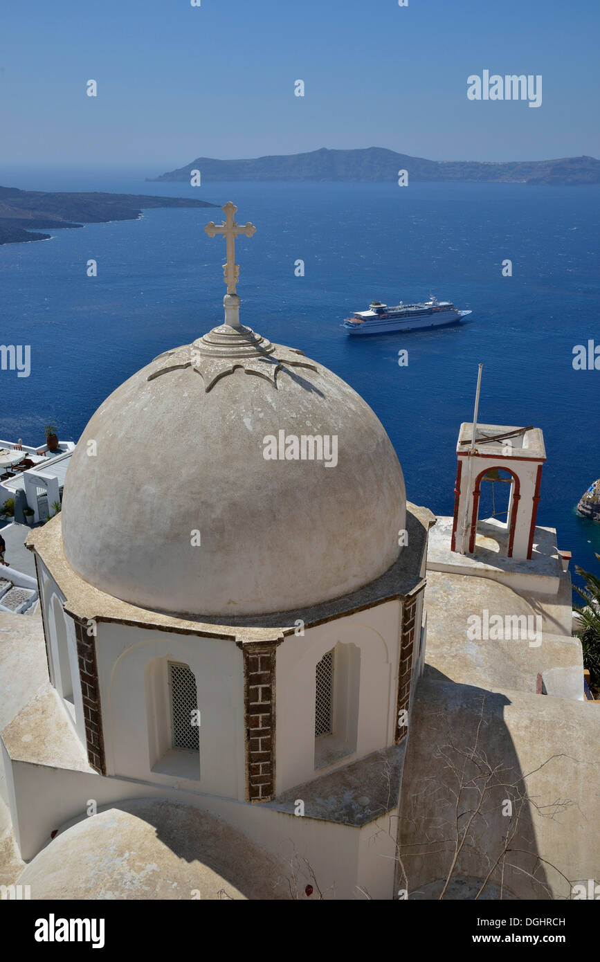 View from the crater rim across the rooftops of Firá or Thira into the Caldera, Ágios Ioánnis church at front, Santorini Stock Photo