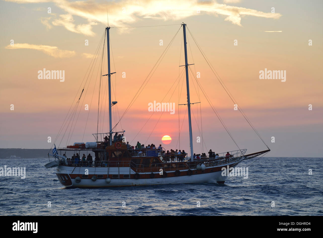 Sailing ship at sunset near Oía, Santorini, Cyclades, Greek Islands, Greece, Europe Stock Photo