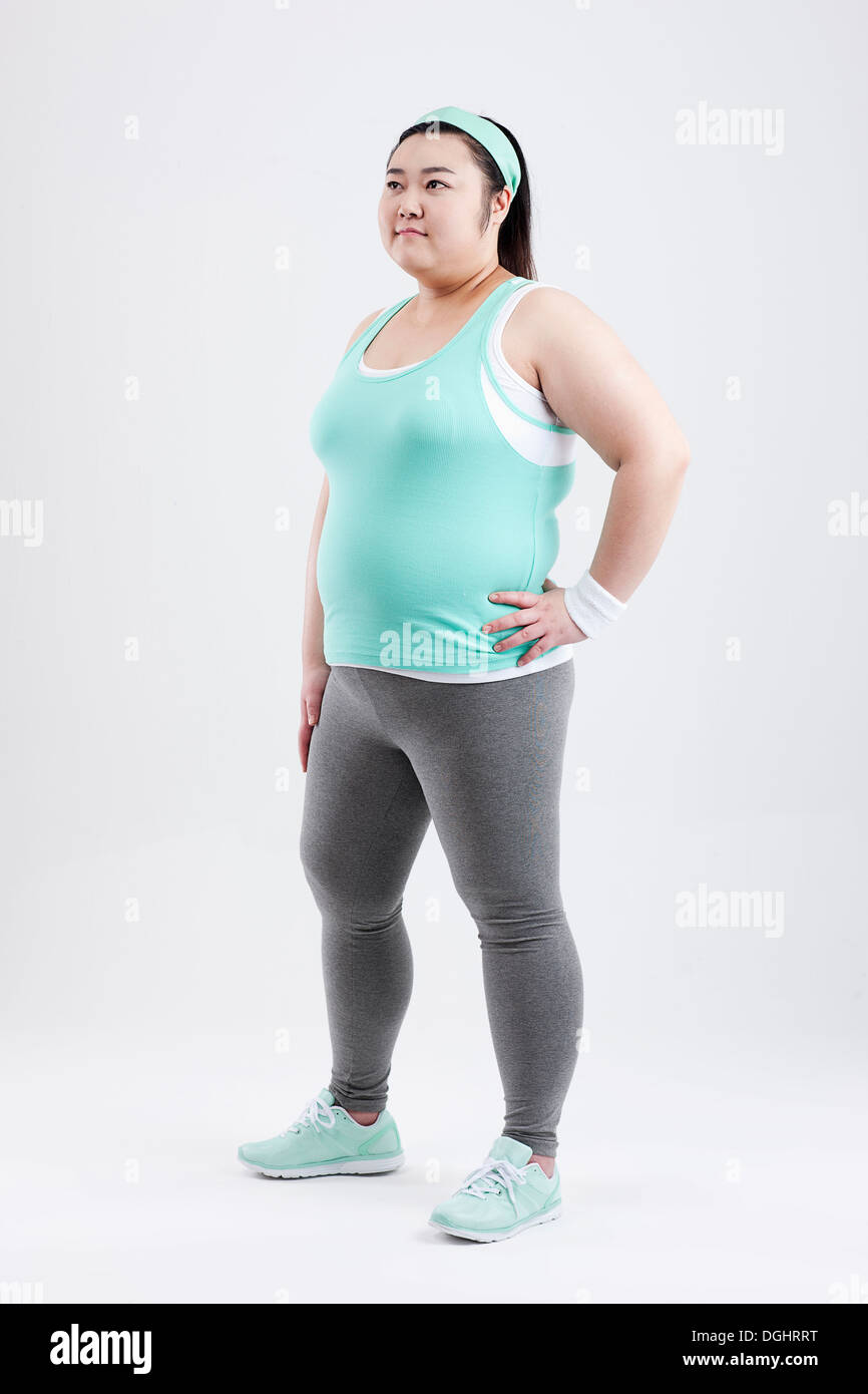 a fat girl standing in a gym outfit Stock Photo - Alamy