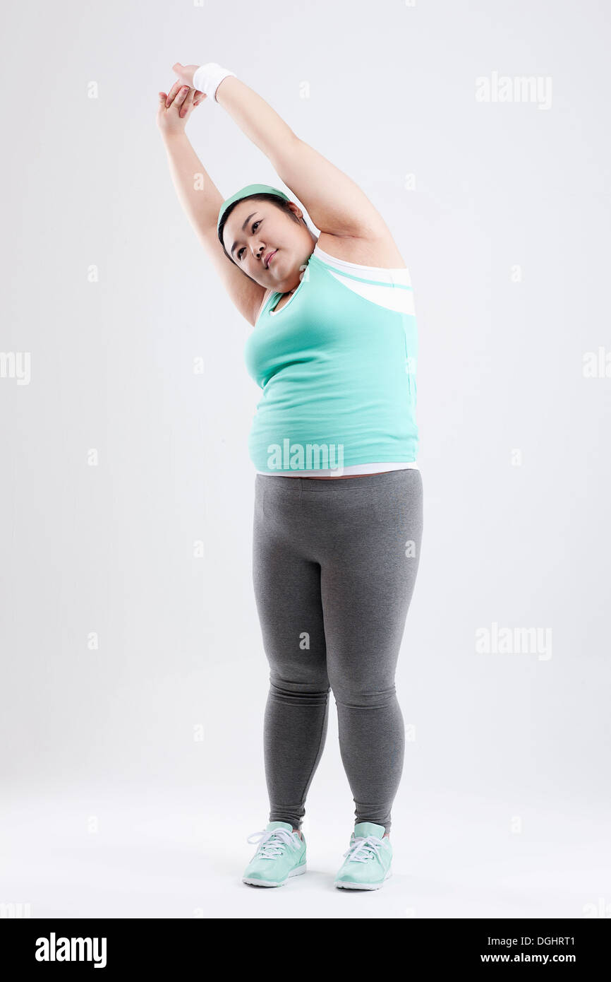 Fat girl stretching in gym hi-res stock photography and images - Alamy