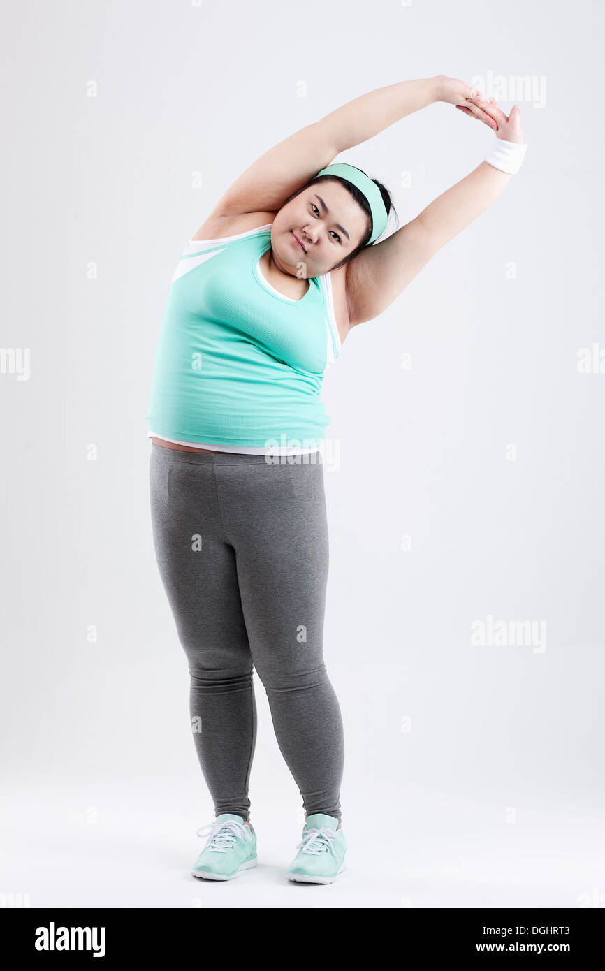 a fat girl stretching in a gym outfit Stock Photo - Alamy