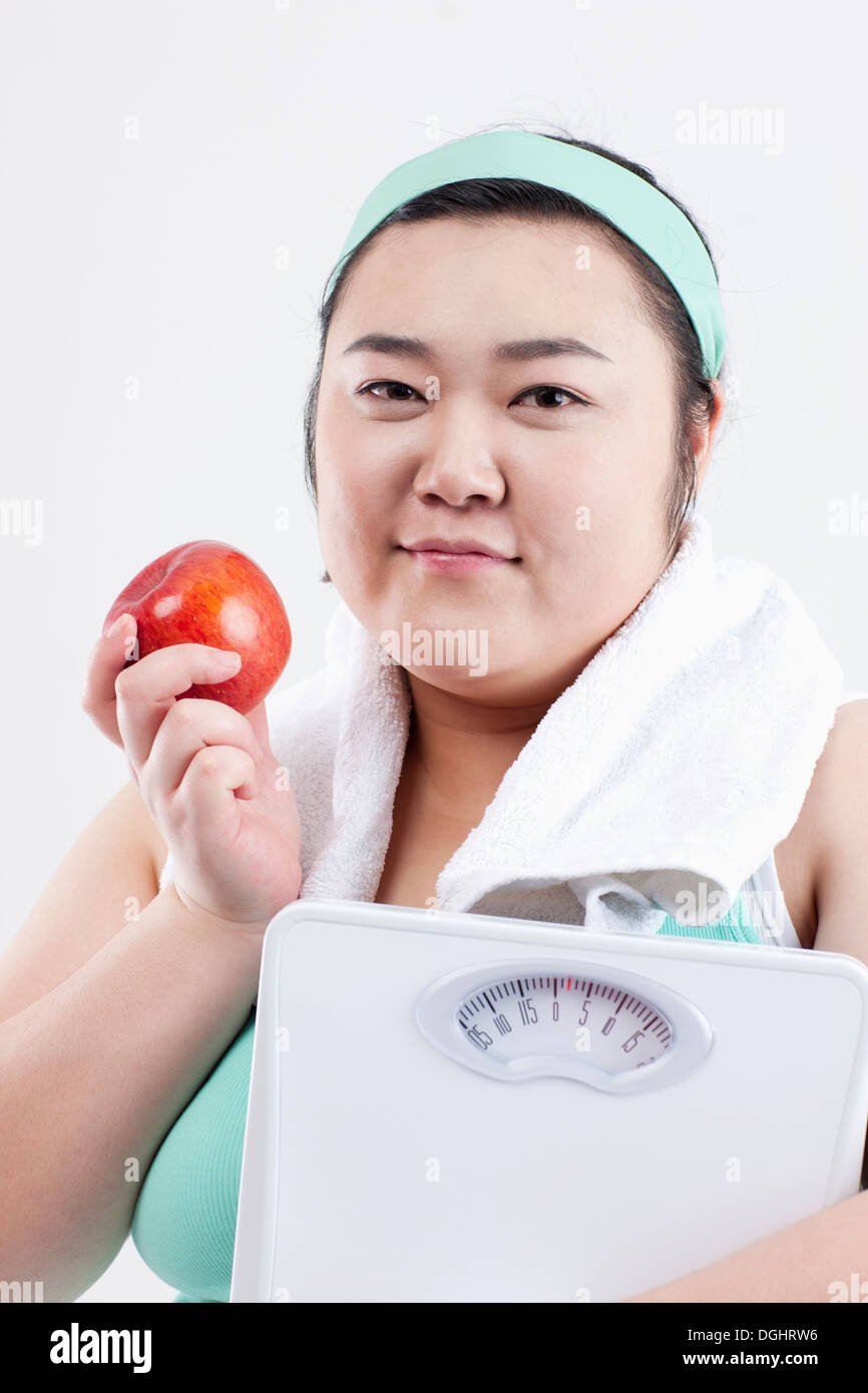 https://c8.alamy.com/comp/DGHRW6/a-fat-girl-in-a-gym-outfit-holding-a-weight-scale-DGHRW6.jpg