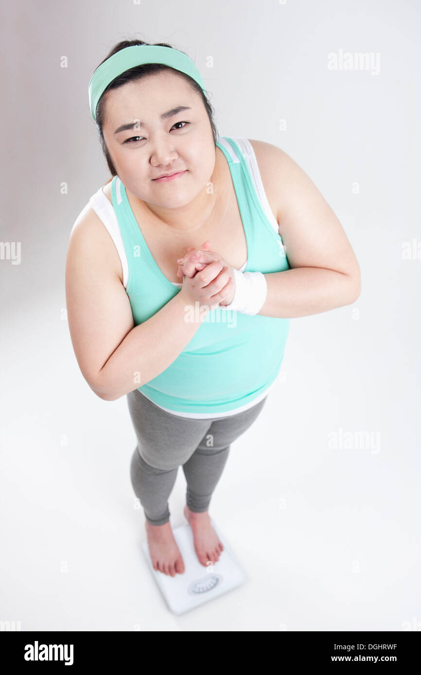 a fat girl in a gym outfit measuring herself Stock Photo Alamy