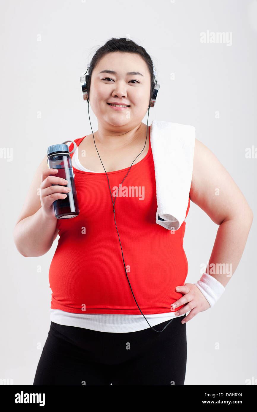 a fat girl listening to music in a gym outfit Stock Photo Alamy