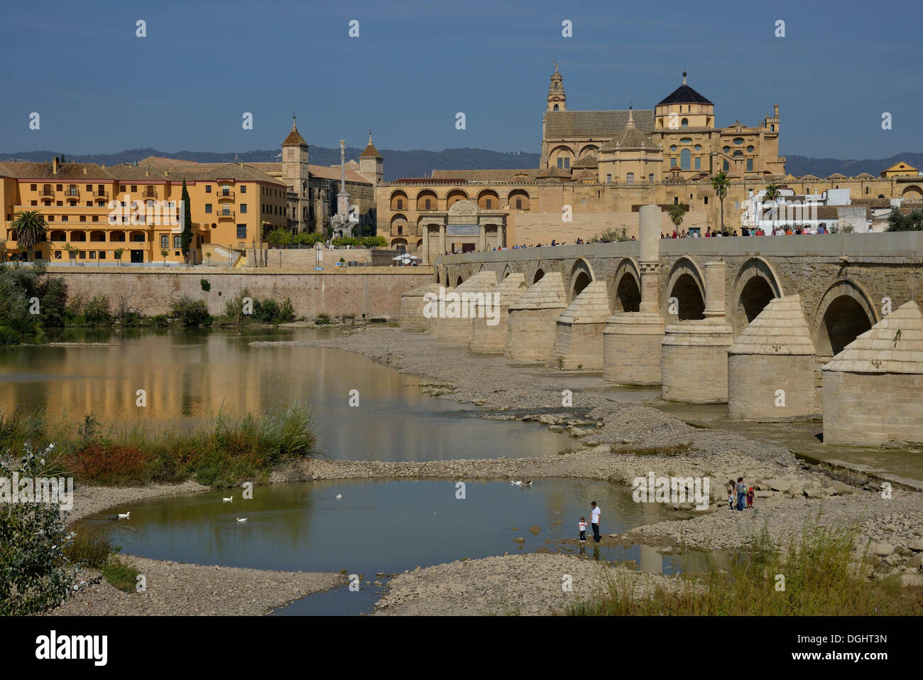 Roman bridge, Puente Viejo, over the Guadalquivir river, Mosque–Cathedral of Córdoba or Mezquita at back, Córdoba Stock Photo