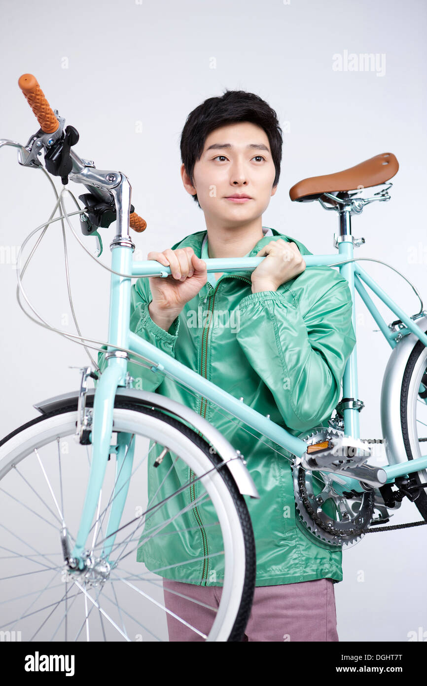 a man carrying a bicycle Stock Photo Alamy