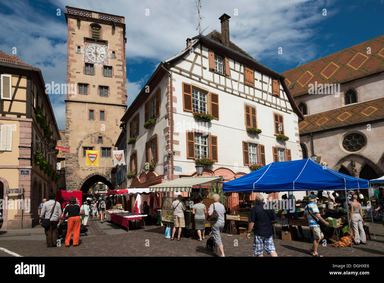Place de Hotel de Ville with a market and the city tower, historic center, Ribeauvillé, Alsace, France Stock Photo
