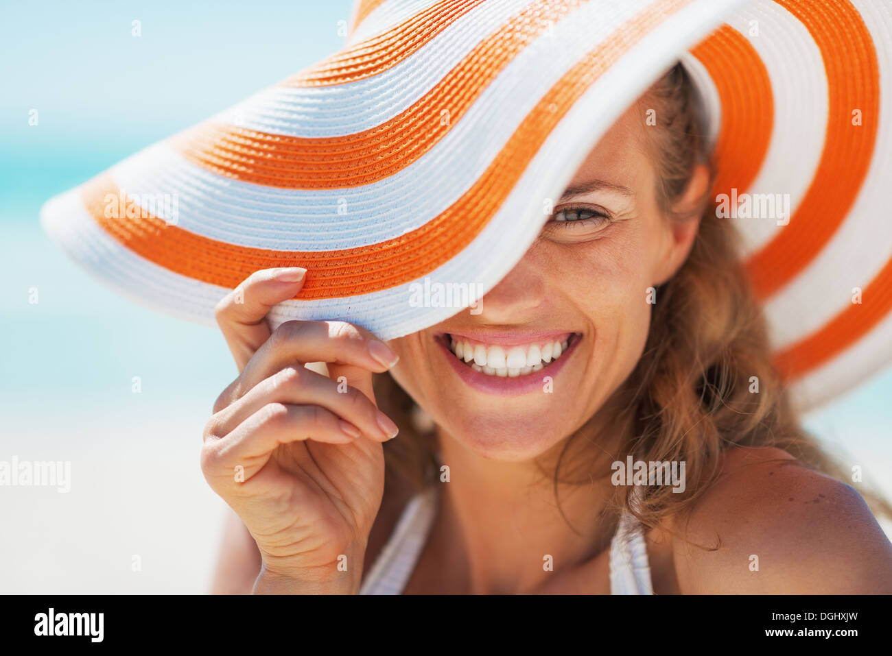 Portrait of happy young woman in swimsuit and beach hat Stock Photo - Alamy