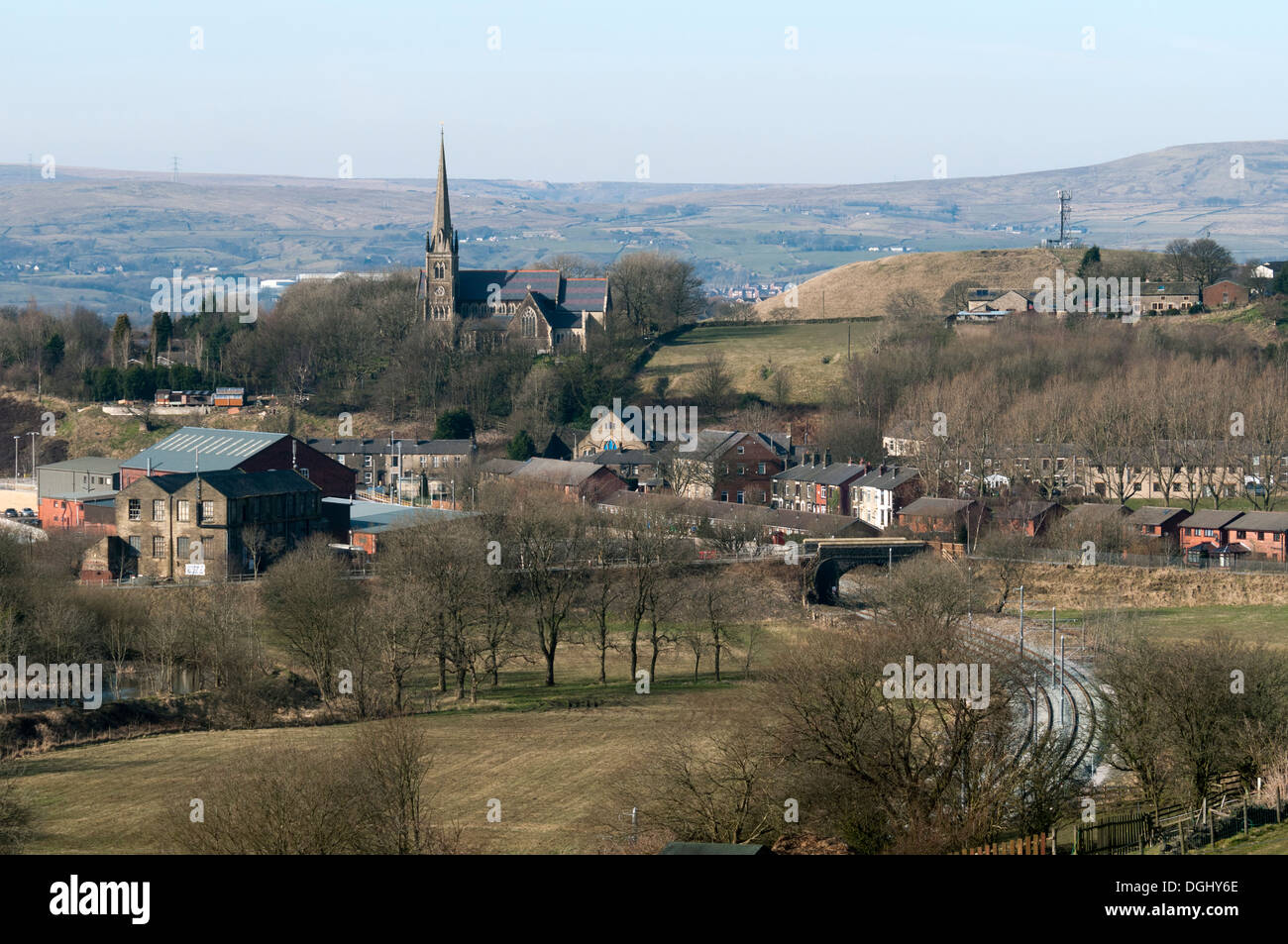 St Thomas' Church over the Beal valley, Newhey, Rochdale, Greater Manchester England, UK. Metrolink tram tracks in foreground. Stock Photo