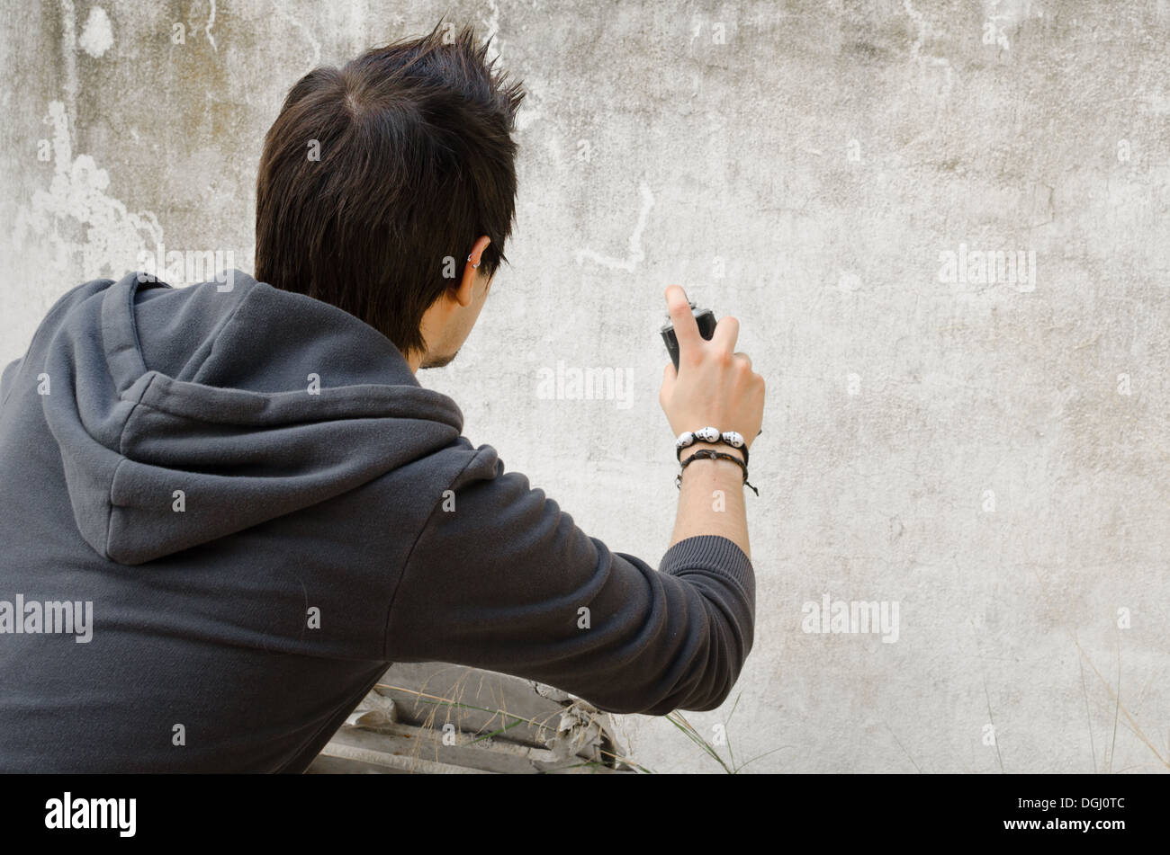Male teen painting wall spray paint hi-res stock photography and images ...