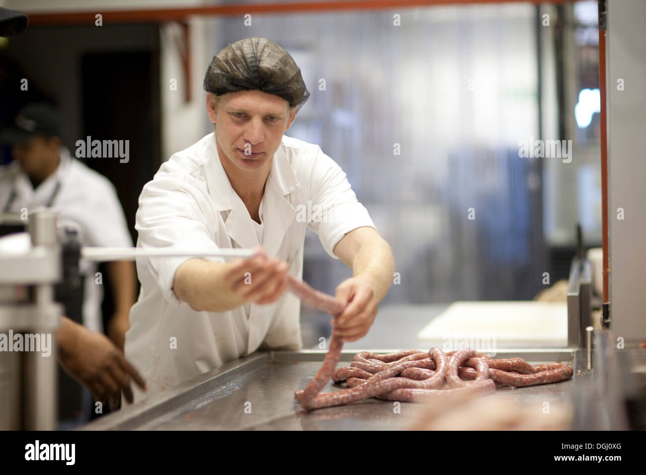 Butcher making sausages Stock Photo Alamy