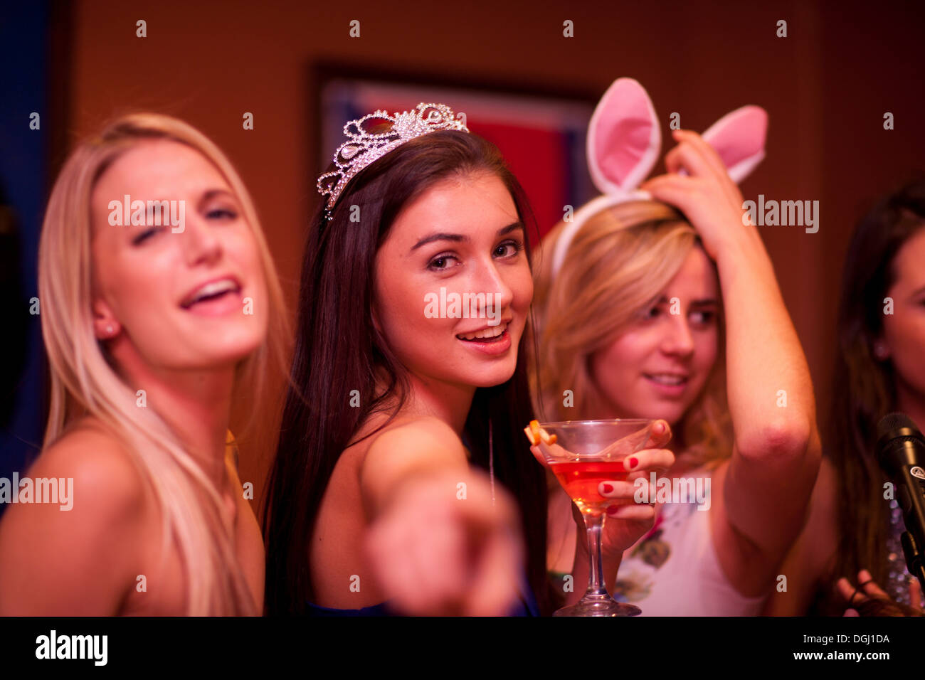 Young woman wearing tiara holding cocktail Stock Photo