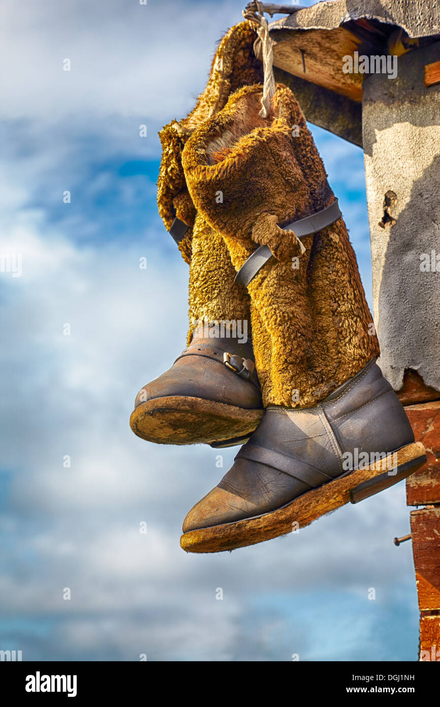 Unty, Mukluk - Hunter's high fur boots, traditional siberian design known for hundreds of years, drying on the wall outdoors Stock Photo