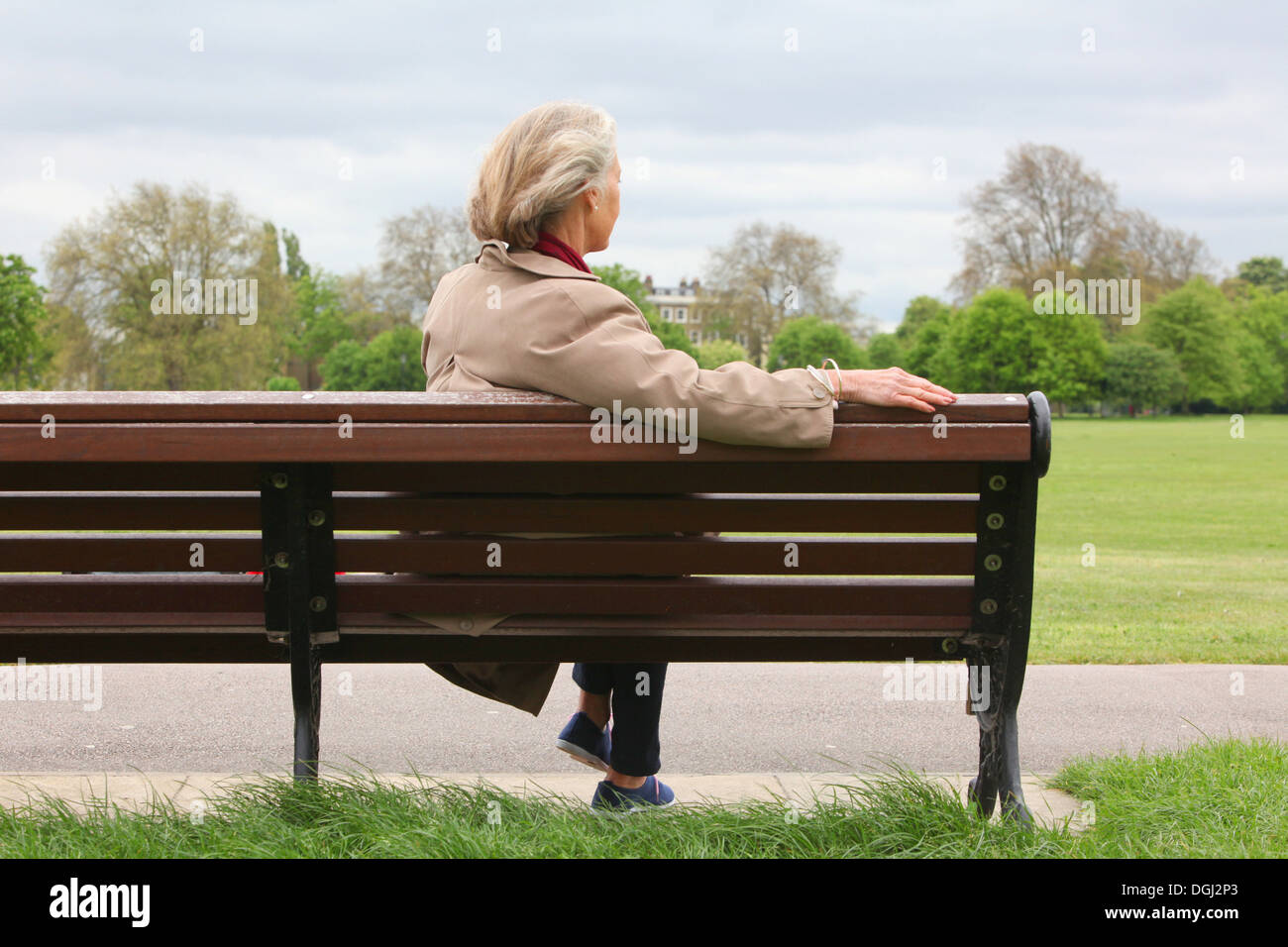 Senior woman sitting on park bench, rear view Stock Photo