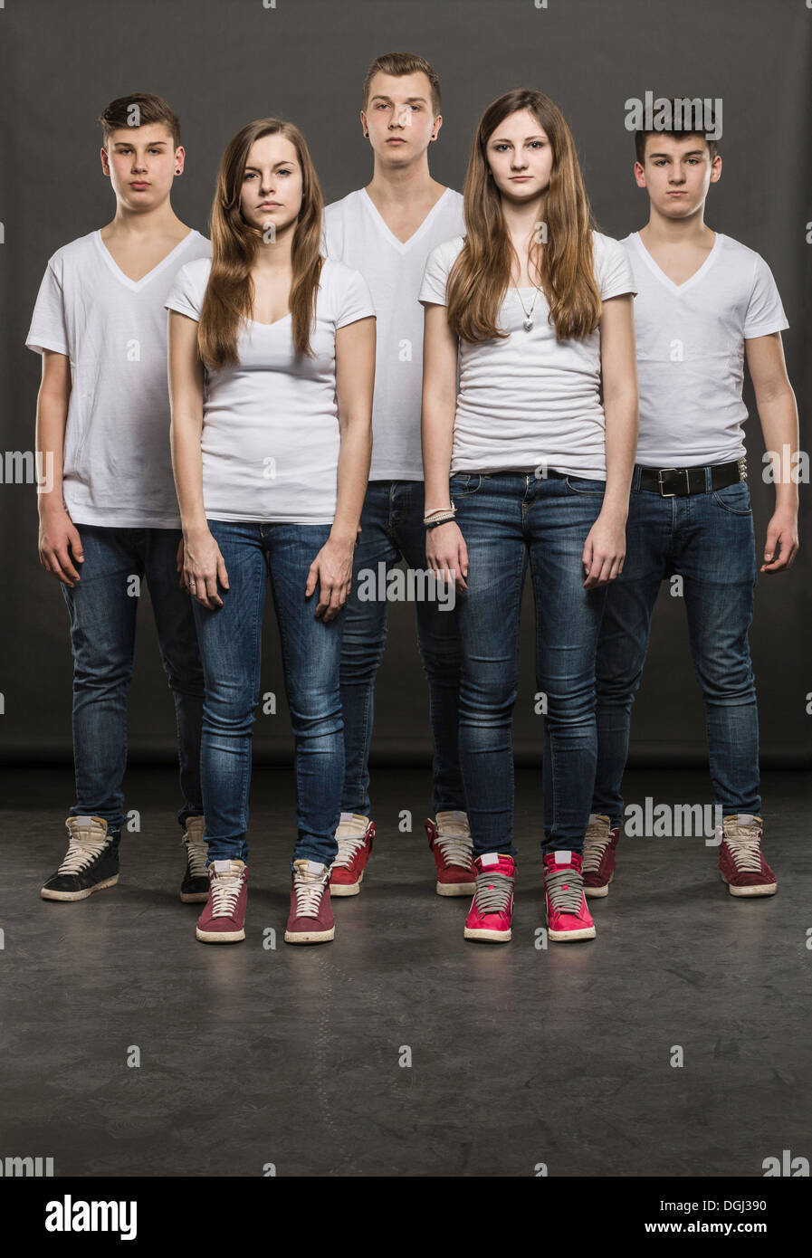 Five teenagers standing in a group Stock Photo